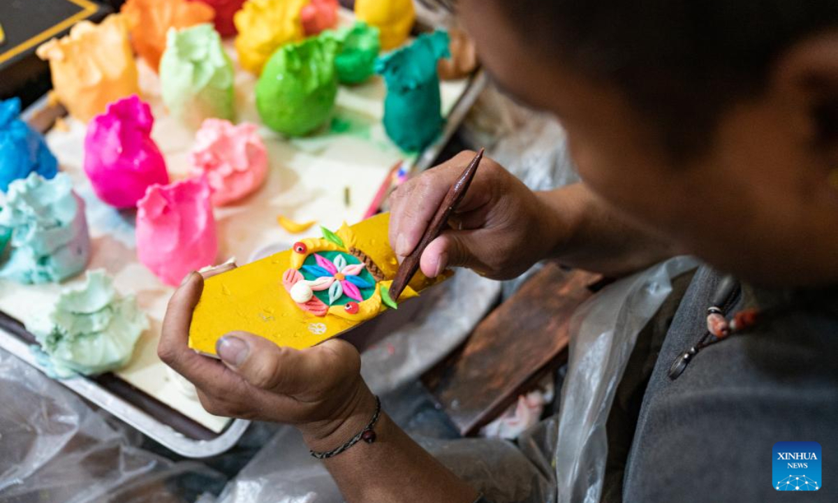 A craftsman makes butter sculptures in Lhasa, southwest China's Xizang Autonomous Region, Feb 7, 2024. The Tibetan New Year coincides with the Lunar New Year, or the Spring Festival, which falls on Feb 10 this year. As the New Year is approaching, butter sculptures handmade by local craftsmen sell quite well in Xizang. Photo:Xinhua