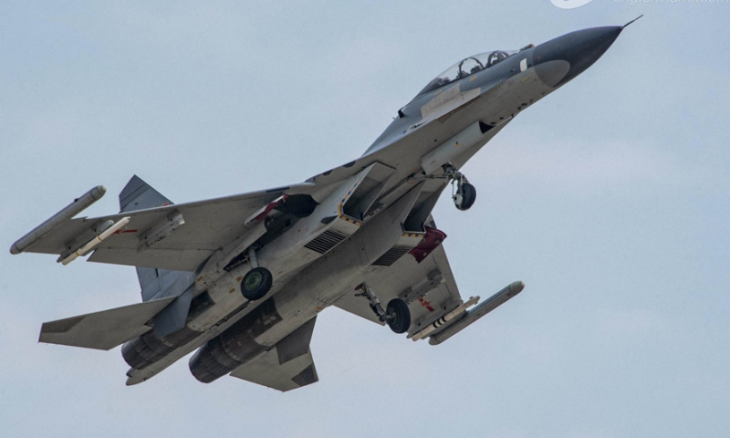 Fighter jet attached to an aviation brigade of the air force soars into the air during a flight training exercise on February 20, 2024. (eng.chinamil.com.cn/Photo by Fu Gan)