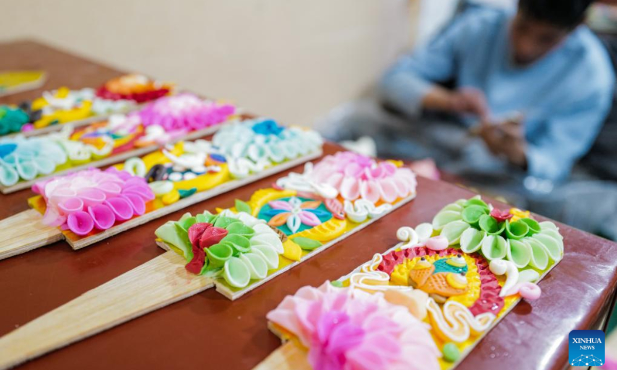 A craftsman makes butter sculptures in Lhasa, southwest China's Xizang Autonomous Region, Feb 7, 2024. The Tibetan New Year coincides with the Lunar New Year, or the Spring Festival, which falls on Feb 10 this year. As the New Year is approaching, butter sculptures handmade by local craftsmen sell quite well in Xizang. Photo:Xinhua