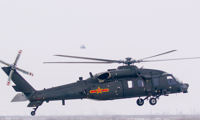 A helicopter attached to a brigade under the PLA 71st Group Army lifts off for a training mission  after snow on February 20, 2024. The mission aimed to beef up the pilots' rapid response and special situation handling capabilities. (eng.chinamil.com.cn/Photo by Li Jingyou)