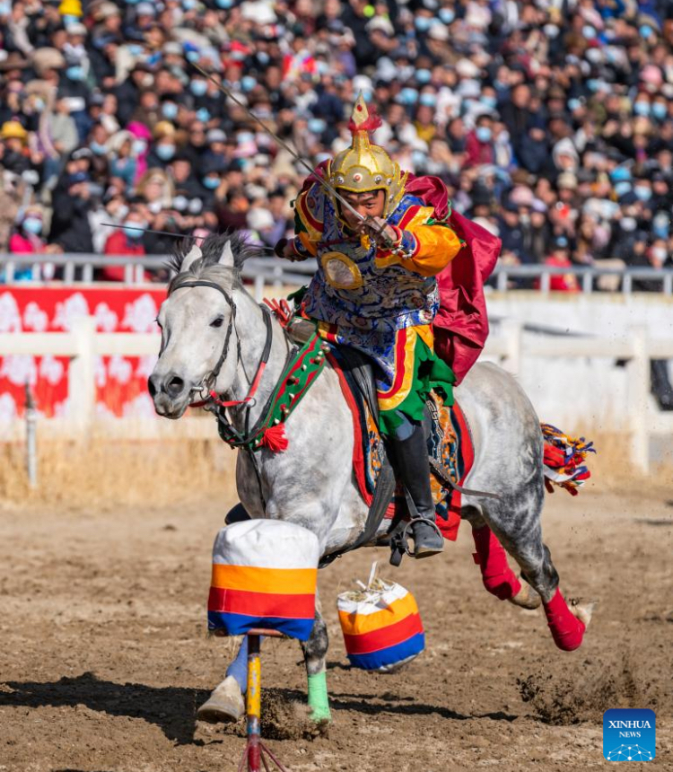 A rider performs in Lhasa, southwest China's Xizang Autonomous Region, Feb. 12, 2024. The equestrian team of southwest China's Xizang Autonomous Region staged a thrilling display of traditional horse racing in its capital Lhasa on Monday, the third day of the Tibetan New Year. The riders were dressed in colorful Tibetan clothes and galloped gracefully around the racecourse in the northern suburbs of Lhasa. (Photo: Xinhua)