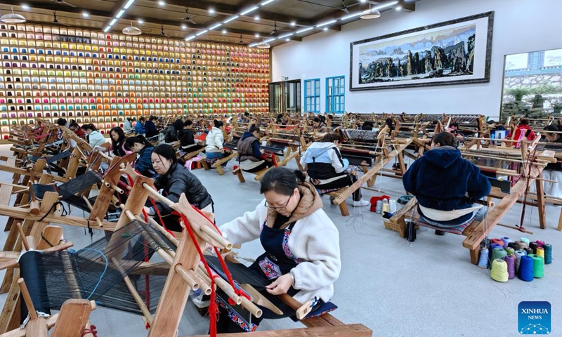 Artisans weave Tujia traditional hand-made brocades at the Guaiyaomei Tujia ethnic brocade innovative factory in Zhangjiajie, central China's Hunan Province, Nov. 12, 2023. (Xinhua)