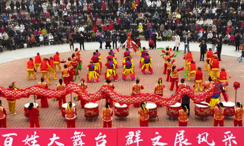 An aerial drone photo taken on Feb. 18, 2024 shows people watching a drum dance in Huyi District, Xi'an of northwest China's Shaanxi Province. (Xinhua/Liu Xiao)