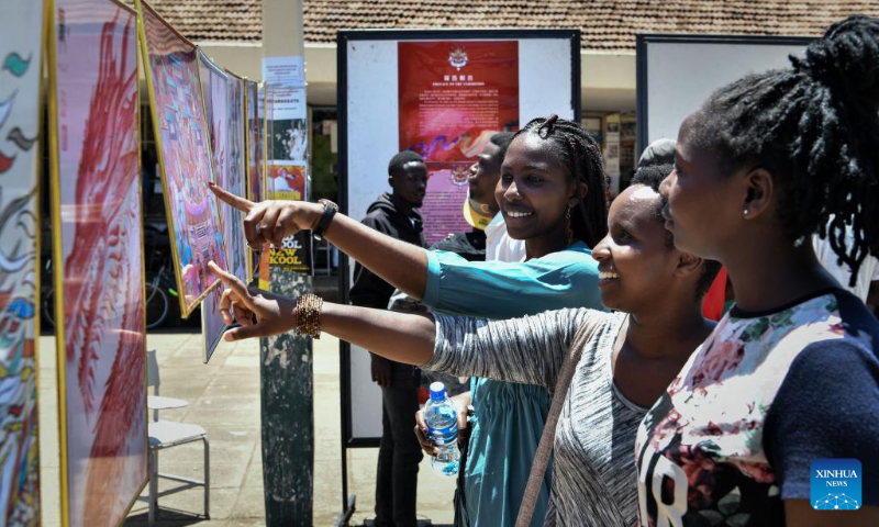 Students look at artworks during the Dragon Design Exhibition held at Kenyatta University in Nairobi, Kenya, Feb. 15, 2024. The day-long event showcasing different aspects of the Chinese dragon was held Thursday at Kenyatta University, Kenya's second oldest public university. (Xinhua/Han Xu)