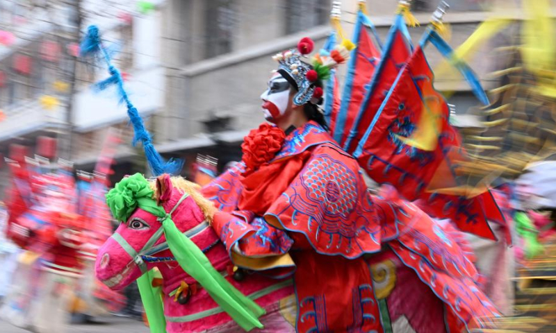 Actors of dozens of Shehuo folk performance teams perform at a temple fair in Xunxian County, central China's Henan Province just after the Lantern Festival in 2023.