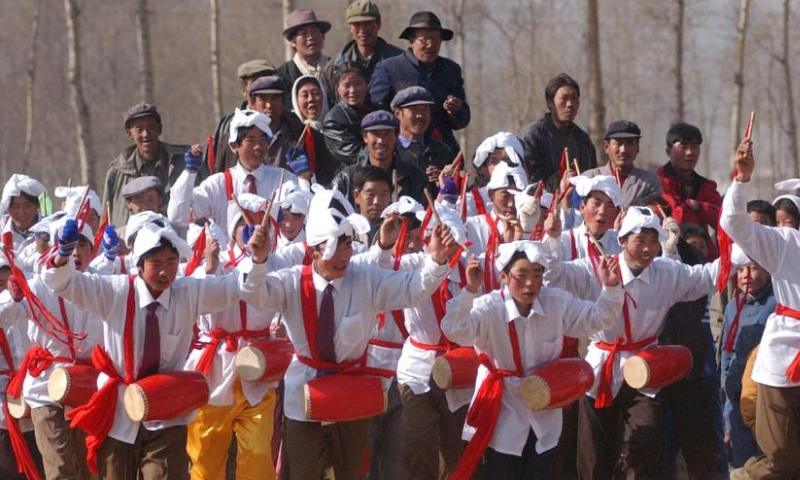 Members of a Shehuo folk performance team rehearse in Changning Township of Datong County in Xining, northwest China's Qinghai Province before the Spring Festival in 2003.