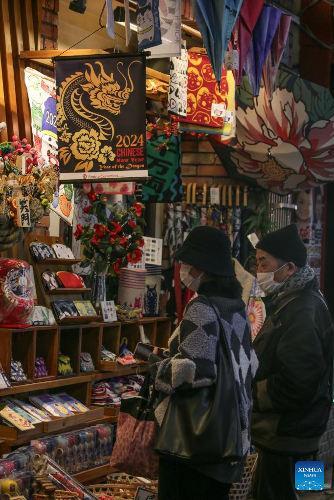 People shop in the Chinatown of Yokohama, Japan, Feb. 11, 2024. Tourists came to the Chinatown to enjoy festive atmosphere of the Spring Festival. (Xinhua/Yue Chenxing)