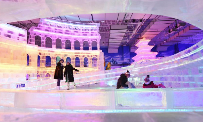 Tourists have fun at an ice and snow art gallery of the Sun Island scenic spot in Harbin, northeast China's Heilongjiang Province, Feb. 23, 2024. Covering an area of nearly 5,000 square meters, this indoor ice and snow art gallery wowed tourists with ice sculptures and various ice and snow entertainment. (Xinhua/Wang Jianwei)