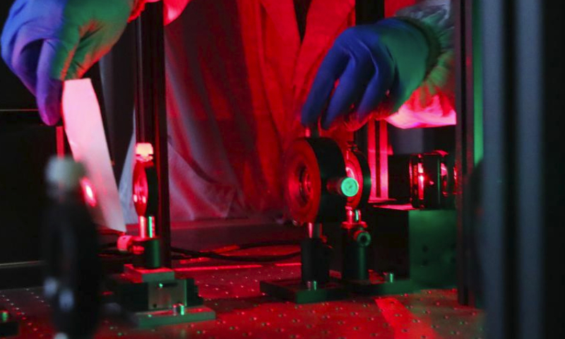 Researcher Zhao Miao debugs experiment equipment at a laboratory in the Shanghai Institute of Optics and Fine Mechanics, Chinese Academy of Sciences in east China's Shanghai, Feb. 29, 2024. (Xinhua/Fang Zhe)