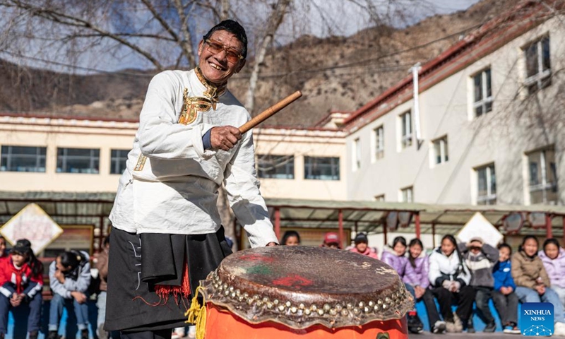 Tengpa Anye plays the drum to accompany lion dance at a primary school in Xobando Town of Lhorong County in Qamdo City, southwest China's Xizang Autonomous Region, Jan. 19, 2024.