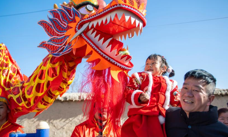 A Shehuo folk performance team visit Zijin Village of Jiuquan, northwest China's Gansu Province during the Spring Festival in 2024.
