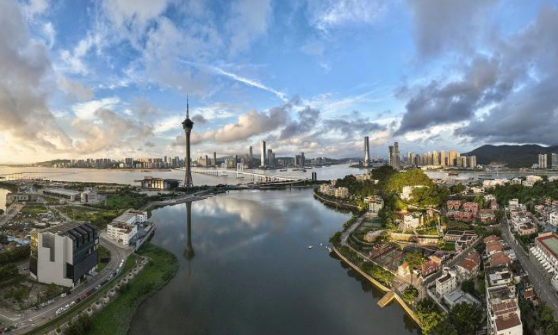 An aerial drone photo taken on July 8, 2022 shows a view of Zhuhai of south China's Guangdong Province and south China's Macao (front). The Guangdong-Hong Kong-Macao Greater Bay Area, a city cluster, is one of the most open areas in China with economic vitality.

The greater bay area is composed of nine cities in Guangdong Province including Guangzhou, Shenzhen, Zhuhai, Foshan, Huizhou, Dongguan, Zhongshan, Jiangmen and Zhaoqing, and two special administrative regions of Hong Kong and Macao. (Photo by Guo Jingwen/Xinhua)