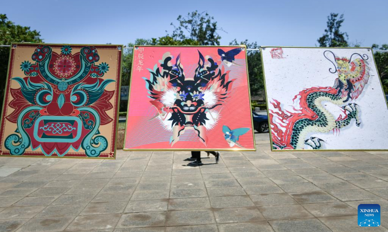 This photo shows artworks on display during the Dragon Design Exhibition held at Kenyatta University in Nairobi, Kenya, Feb. 15, 2024. The day-long event showcasing different aspects of the Chinese dragon was held Thursday at Kenyatta University, Kenya's second oldest public university. (Xinhua/Han Xu)