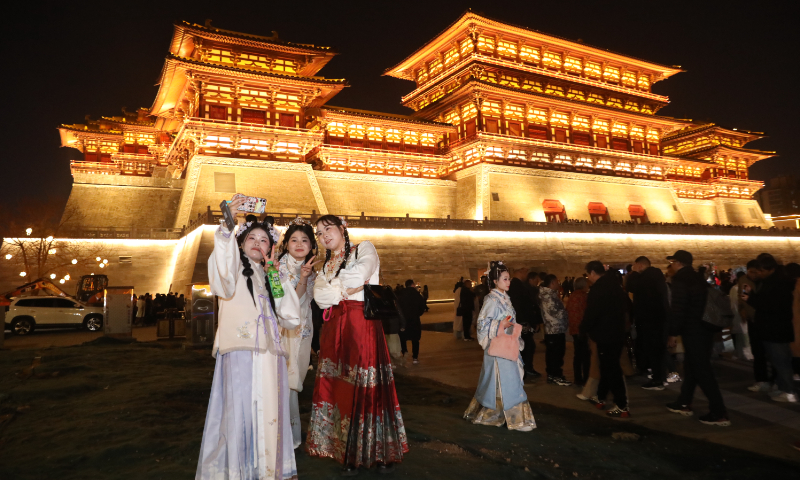 Tourists dressed in hanfu take selfies at the Luoyang City National Heritage Park in Luoyang, Central China's Henan Province, on February 15, 2024. Photo: VCG