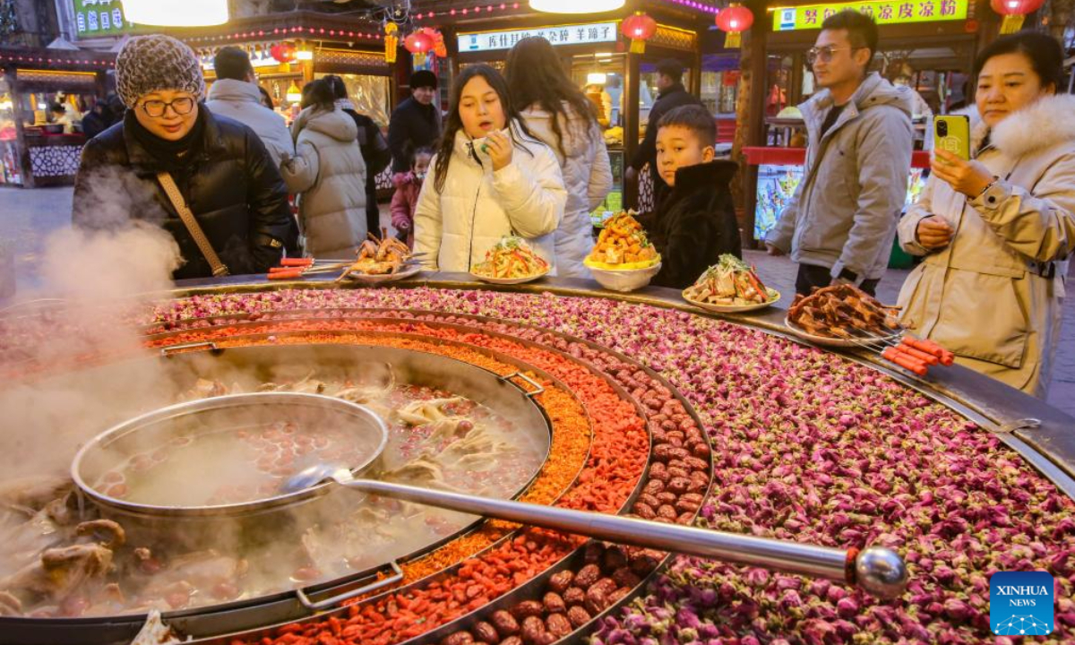 People visit a night market in the ancient city of Kashgar, northwest China's Xinjiang Uygur Autonomous Region, Feb 5, 2024. Photo:Xinhua