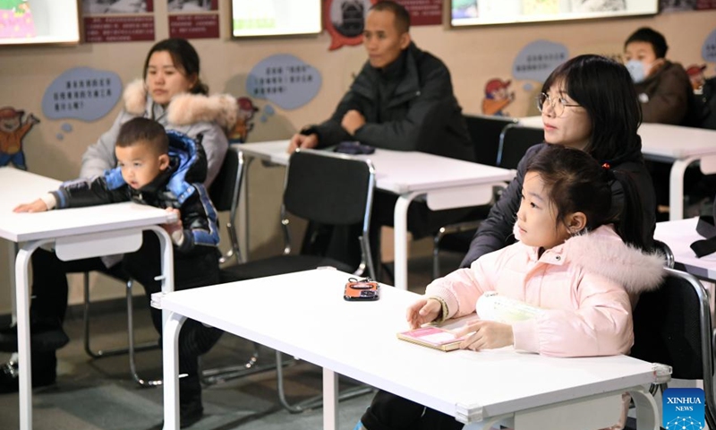 Children and their parents attend a lecture on automobiles at Beijing Auto Museum in Beijing, capital of China, Jan. 28, 2024. Many children visit Beijing Auto Museum with their parents during this winter vacation to attend popular-science lectures and learn about automobile knowledge. (Xinhua/Ren Chao)