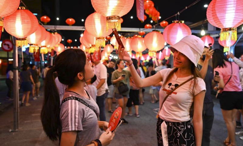 People solve lantern riddles during the Penang Chinese New Year Celebration in George Town, Penang, Malaysia, Feb. 18, 2024. (Photo by Xu Xinyu/Xinhua)