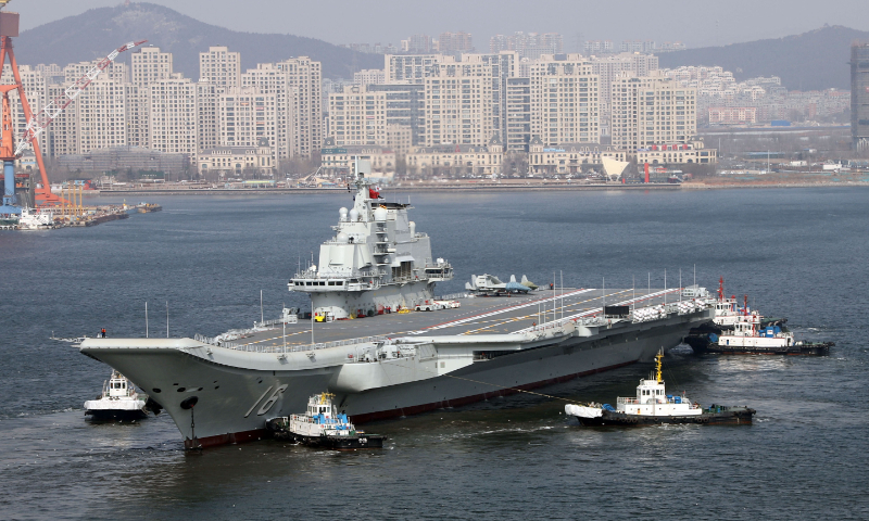 Assisted by several tug boats, China’s aircraft carrier Liaoning sets out from the Dalian Shipyard in Northeast China’s Liaoning Province for a voyage test on February 29, 2024. Full-scale mockups of a J-35 fighter jet and a J-15 fighter jet can be seen on the carrier’s flight deck. Photo: VCG