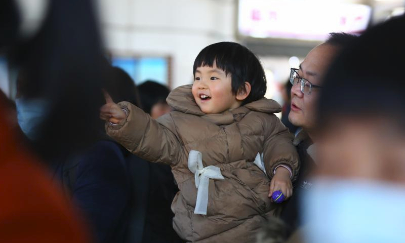 A child waits to get on a train at Tengzhou Railway Station in Tengzhou, east China's Shandong Province, Feb. 16, 2024. China witnessed an increase of passenger trips as this year's Spring Festival holiday is coming to an end. (Photo by Li Zhijun/Xinhua)