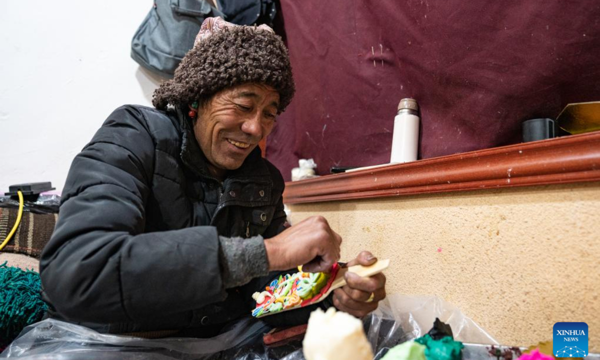 A craftsman makes butter sculptures in Lhasa, southwest China's Xizang Autonomous Region, Feb 7, 2024. The Tibetan New Year coincides with the Lunar New Year, or the Spring Festival, which falls on Feb 10 this year. As the New Year is approaching, butter sculptures handmade by local craftsmen sell quite well in Xizang. Photo:Xinhua
