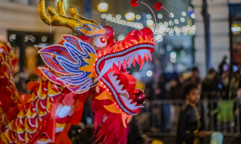 People perform dragon dance in a parade featuring Chinese New Year in San Francisco, the United States, Feb. 24, 2024. (Photo by Dong Xudong/Xinhua)
