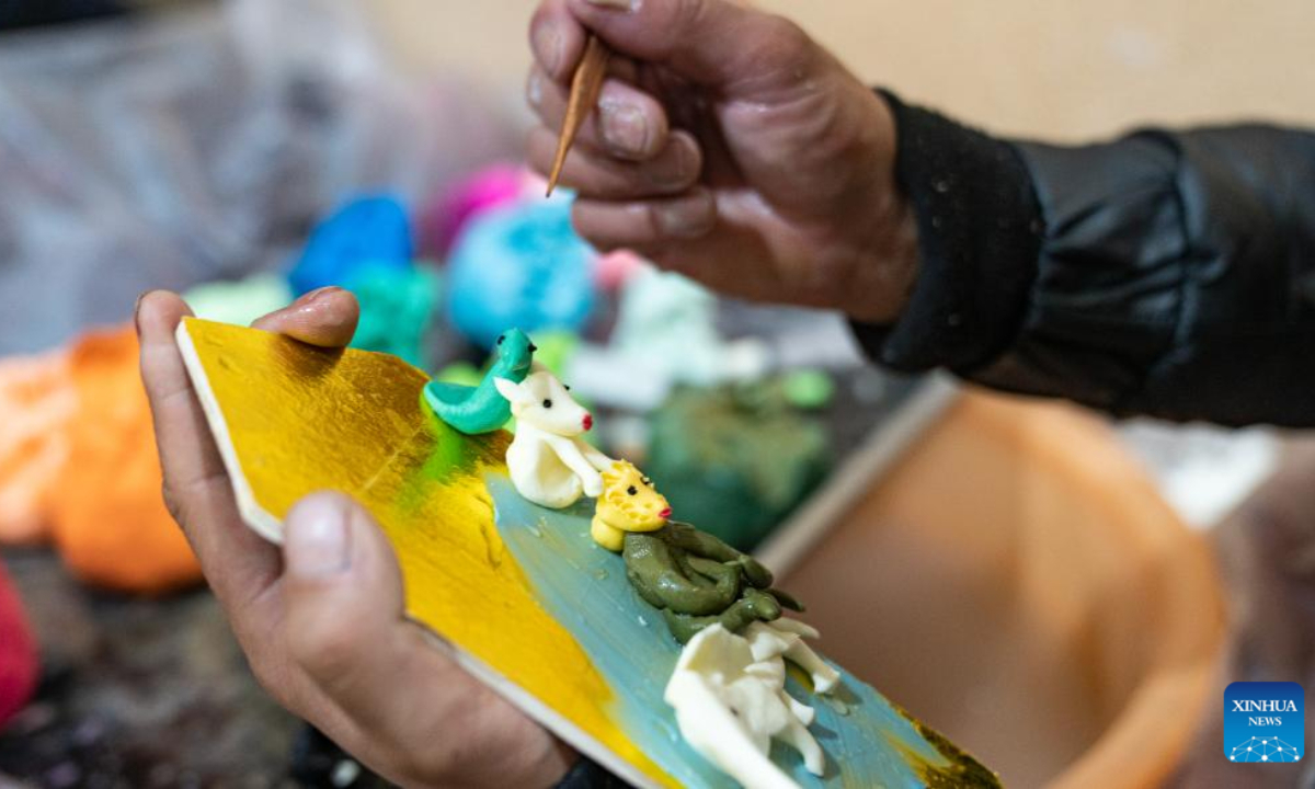 A craftsman makes butter sculptures in Lhasa, southwest China's Xizang Autonomous Region, Feb 7, 2024. The Tibetan New Year coincides with the Lunar New Year, or the Spring Festival, which falls on Feb 10 this year. As the New Year is approaching, butter sculptures handmade by local craftsmen sell quite well in Xizang. Photo:Xinhua