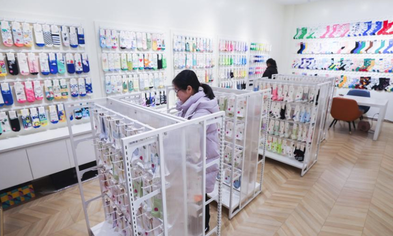 An employee arranges socks at a shop at the Datang subdistrict in Zhuji, east China's Zhejiang Province, Feb. 24, 2024.

Production lines of sock companies in east China's Zhuji City, dubbed as the sock capital, are operating at full swing to meet the orders.

As the world's largest sock manufacturing base, the Datang sub-district of Zhuji in Zhejiang Province produces approximately 25 billion pairs of socks yearly, accounting for more than 70 percent of the output of China and one-third of the whole world. (Xinhua/Xu Yu)