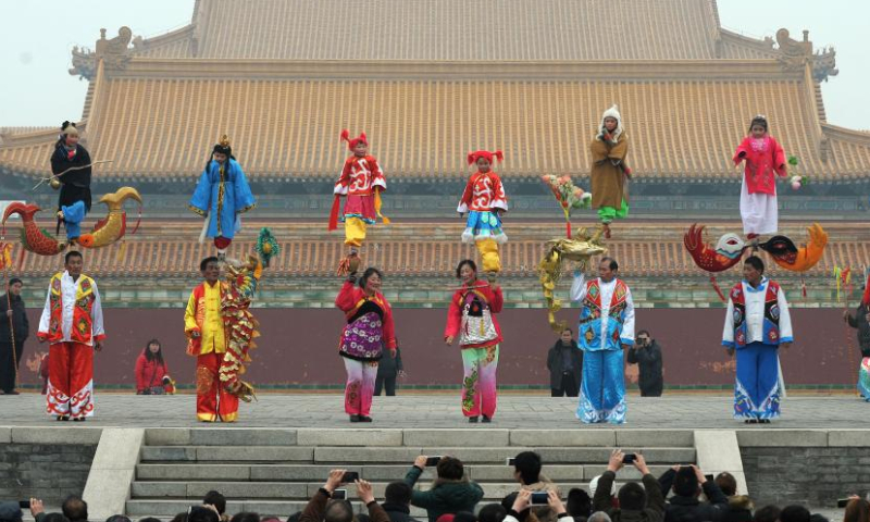 A Shehuo folk performance team performs in Huayin City, northwest China's Shaanxi Province after the Lantern Festival in 2014.