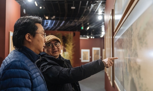 Two visitors discuss an art piece at the <em>Thematic Exhibition of Comprehensive Collection of Ancient Chinese Paintings</em> held at the Beijing World Art Museum in Beijing, China, on January 22, 2024. Photo: Li Hao/GT