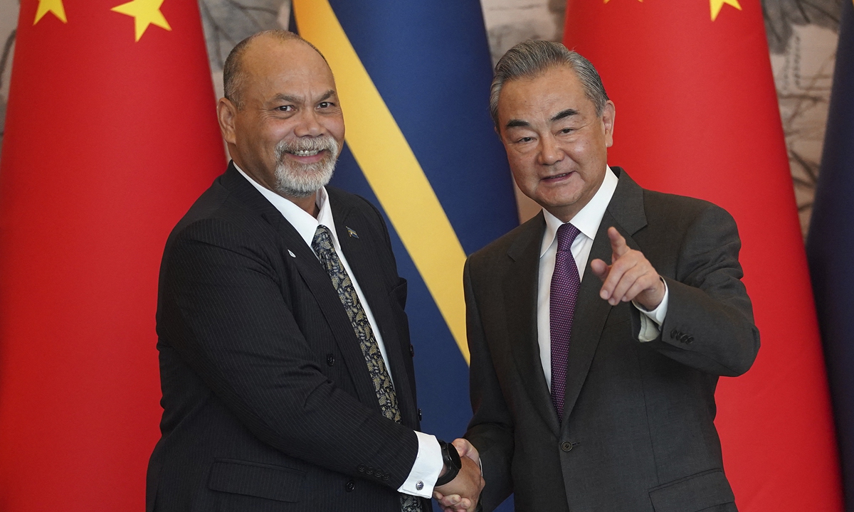 Chinese Foreign Minister Wang Yi (right) shakes hands with Nauru's Minister of Foreign Affairs and Trade Lionel Aingimea after they signed the Joint Communiqué on the Resumption of Diplomatic Relations between China and Nauru, at Diaoyutai State Guesthouse in Beijing on January 24, 2024. Photo: AFP