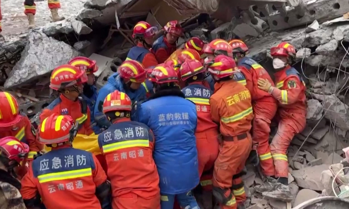 Rescuers work together to search and save victims from the ruins after landslide in the Zhenxiong County, the city of Zhaotong, Southwest China's Yunnan Province, on January 22, 2024. Photo: VCG 