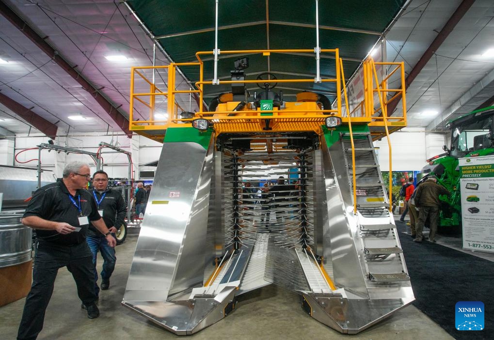 Visitors look at a berry harvester during the Pacific Agriculture Show in Abbotsford, British Columbia, Canada, on Jan. 25, 2024. The 26th annual Pacific Agricultural Show runs from Jan. 25 to 27 in Abbotsford, Canada. More than 300 exhibitors showcase the latest equipment and technology for the agriculture industry, attracting thousands of farmers and producers.(Photo: Xinhua)
