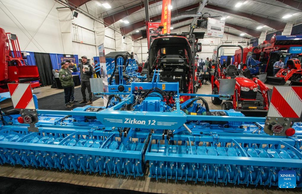 A combine harvester is displayed during the Pacific Agriculture Show in Abbotsford, British Columbia, Canada, on Jan. 25, 2024. The 26th annual Pacific Agricultural Show runs from Jan. 25 to 27 in Abbotsford, Canada. More than 300 exhibitors showcase the latest equipment and technology for the agriculture industry, attracting thousands of farmers and producers.(Photo: Xinhua)