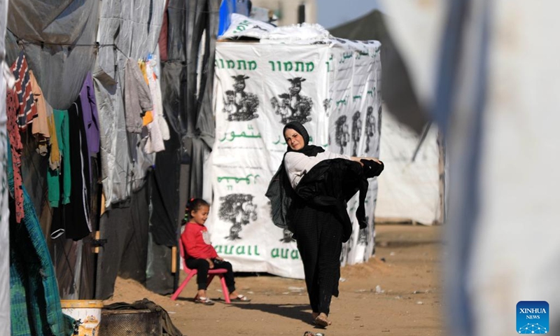 People are seen at a temporary camp in the southern Gaza Strip city of Rafah, on Jan. 26, 2024. The Palestinian death toll from the ongoing Israeli attacks on the Gaza Strip has risen to 26,083 since Oct. 7, 2023, the Hamas-run Health Ministry said on Friday. (Photo by Yasser Qudih/Xinhua)