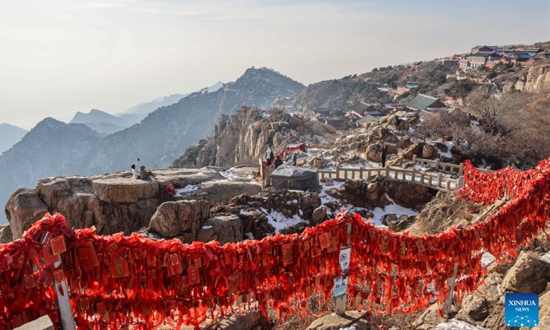 Tourists visit the Mount Tai scenic area in east China's Shandong Province, Jan. 26, 2024. With its natural and cultural values well interconnected, Mount Tai was listed as a World Cultural and Natural Heritage site by UNESCO in 1987, the first ever in China. In 2023, the Mount Tai scenic area received over 8.61 million visitors, a new record over the years. (Xinhua/Zhu Zheng)