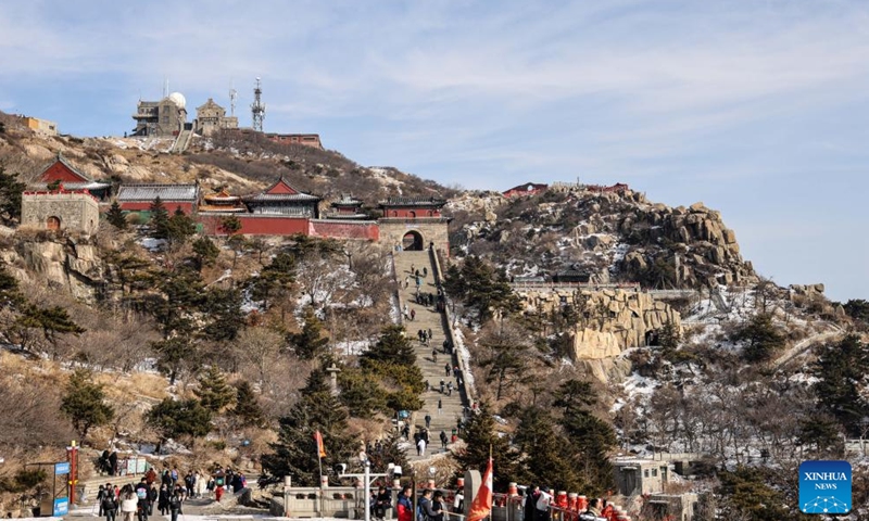 Tourists visit the Mount Tai scenic area in east China's Shandong Province, Jan. 26, 2024. With its natural and cultural values well interconnected, Mount Tai was listed as a World Cultural and Natural Heritage site by UNESCO in 1987, the first ever in China. In 2023, the Mount Tai scenic area received over 8.61 million visitors, a new record over the years. (Xinhua/Zhu Zheng)