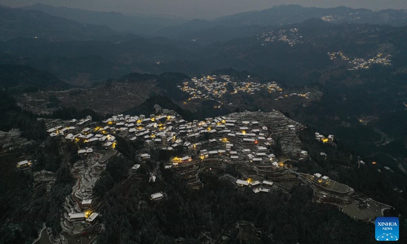An aerial drone photo taken on Jan. 25, 2024 shows the night view of Gandong Village in Gandong Township of Rongshui Miao Autonomous County, south China's Guangxi Zhuang Autonomous Region. Miao ethnic people in high mountainous villages of Liuzhou are busy preparing celebratory merchandise, hosting feasts, and rehearsing festive events ahead of the upcoming Chinese New Year despite the freezing weather. (Xinhua/Huang Xiaobang)