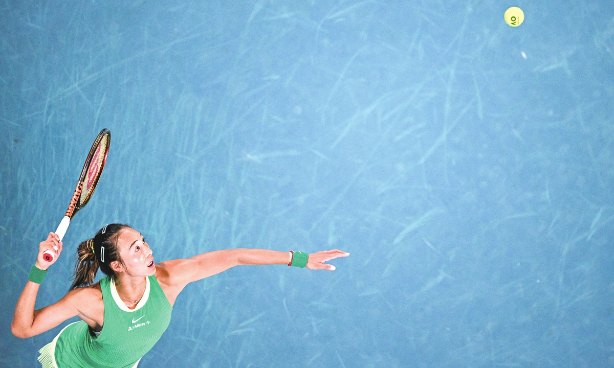Zheng Qinwen serves in the women's singles semi-final match during Australian Open in Melbourne on January 25, 2024. Photo: VCG