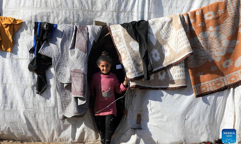 A girl is seen at a temporary camp in the southern Gaza Strip city of Rafah, on Jan. 26, 2024. The Palestinian death toll from the ongoing Israeli attacks on the Gaza Strip has risen to 26,083 since Oct. 7, 2023, the Hamas-run Health Ministry said on Friday. (Photo by Yasser Qudih/Xinhua)