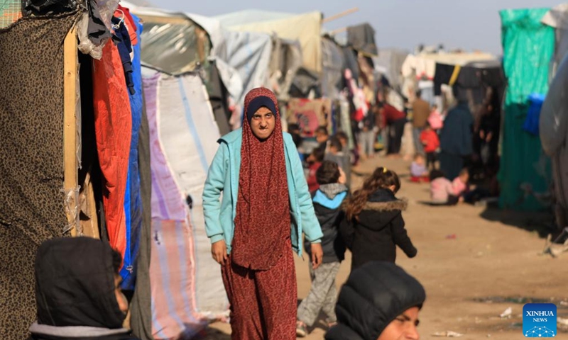 People are seen at a temporary camp in the southern Gaza Strip city of Rafah, on Jan. 26, 2024. The Palestinian death toll from the ongoing Israeli attacks on the Gaza Strip has risen to 26,083 since Oct. 7, 2023, the Hamas-run Health Ministry said on Friday. (Photo by Yasser Qudih/Xinhua)