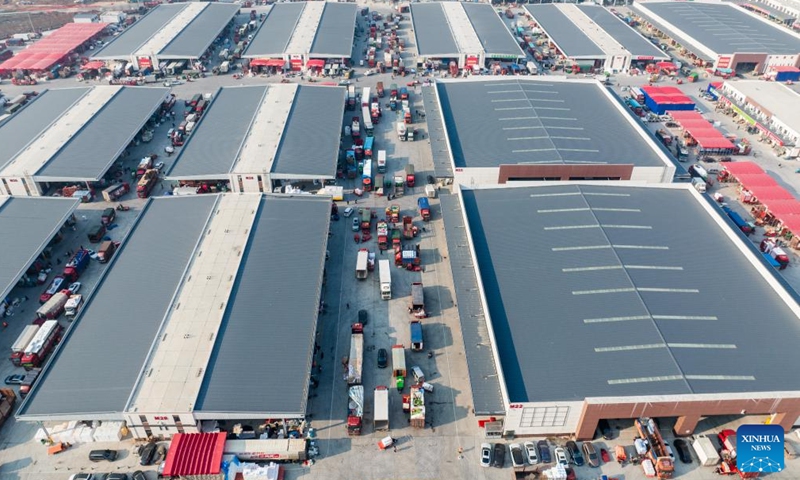 An aerial drone photo taken on Jan. 27, 2024 shows an agricultural trade center in Xiaogan, central China's Hubei Province. The agricultural trade center, which houses nearly 3,000 dealers of fruits, vegetables, aquatic and frozen products, has taken extra measures to ensure its supply for the upcoming Spring Festival holiday. (Xinhua/Wu Zhizun)