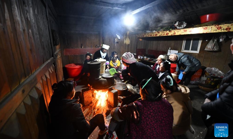 Villagers prepare sticky rice for a feast on the next day at Dangjiu Village in Gandong Township of Rongshui Miao Autonomous County, south China's Guangxi Zhuang Autonomous Region, Jan. 23, 2024. Miao ethnic people in high mountainous villages of Liuzhou are busy preparing celebratory merchandise, hosting feasts, and rehearsing festive events ahead of the upcoming Chinese New Year despite the freezing weather. (Xinhua/Huang Xiaobang)