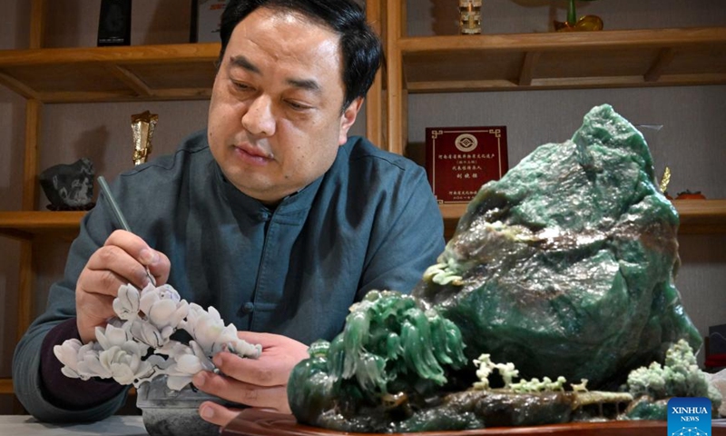 Liu Xiaoqiang conceives his next moves on an unfinished work at his studio in Zhenping County of Nanyang City, central China's Henan Province, Jan. 23, 2024. (Xinhua/Li An)