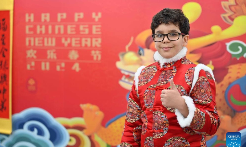 A boy gestures as he participates in a culture event at Kuwait Chinese Cultural Center in Hawalli Governorate, Kuwait, Jan. 25, 2024. A culture event for the upcoming Chinese Spring Festival was held here Thursday, with more than 100 guests gathering to taste traditional food and experience Chinese ink painting, calligraphy, paper-cutting and tea art. (Photo by Asad/Xinhua)