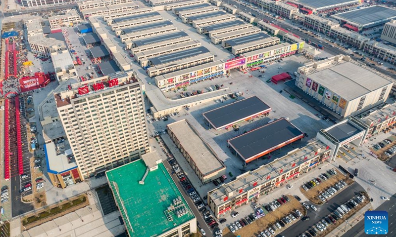 An aerial drone photo taken on Jan. 27, 2024 shows an agricultural trade center in Xiaogan, central China's Hubei Province. The agricultural trade center, which houses nearly 3,000 dealers of fruits, vegetables, aquatic and frozen products, has taken extra measures to ensure its supply for the upcoming Spring Festival holiday. (Xinhua/Wu Zhizun)