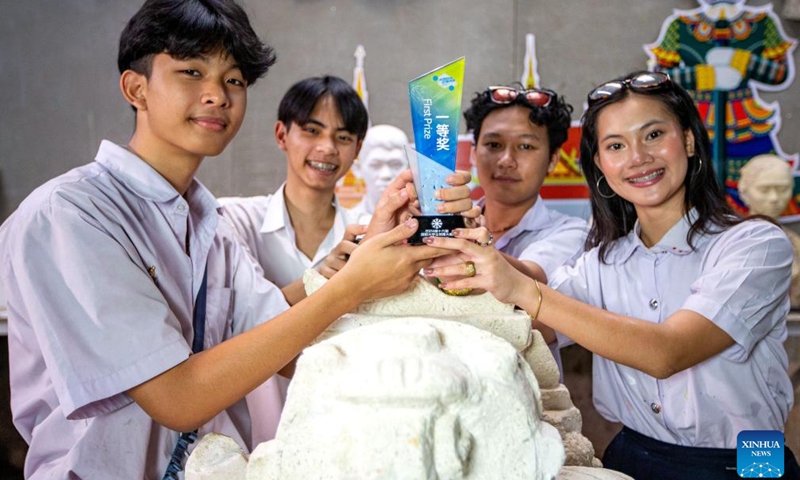 Students of Saowabha Vocational College show the trophy of the 16th international snow sculpture competition for college students in Bangkok, Thailand, Jan. 22, 2024.(Xinhua/Wang Teng)