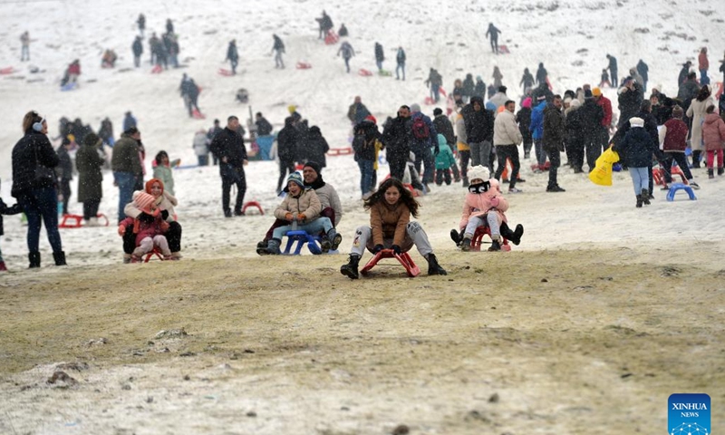 People have fun at a snow resort in Ankara, Türkiye, Jan. 28, 2024. (Photo by Mustafa Kaya/Xinhua)