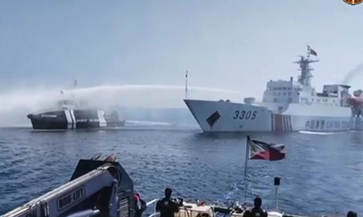A China Coast Guard vessel (right) uses a water cannon to lawfully expel a Philippine vessel near Huangyan Dao in the South China Sea, on December 9, 2023. Photo: VCG