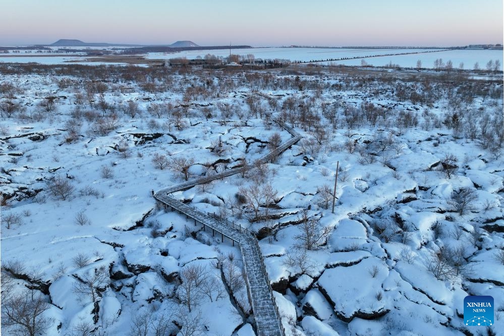 This aerial drone photo taken on Jan. 29, 2024 shows a snow scenery of the Wudalianchi Geopark in Heihe, northeast China's Heilongjiang Province. The Wudalianchi Geopark features 14 volcanoes and five major volcanic barrier lakes. The geopark boasts a complete set of volcanic landforms, making it a natural volcano museum.(Photo: Xinhua)