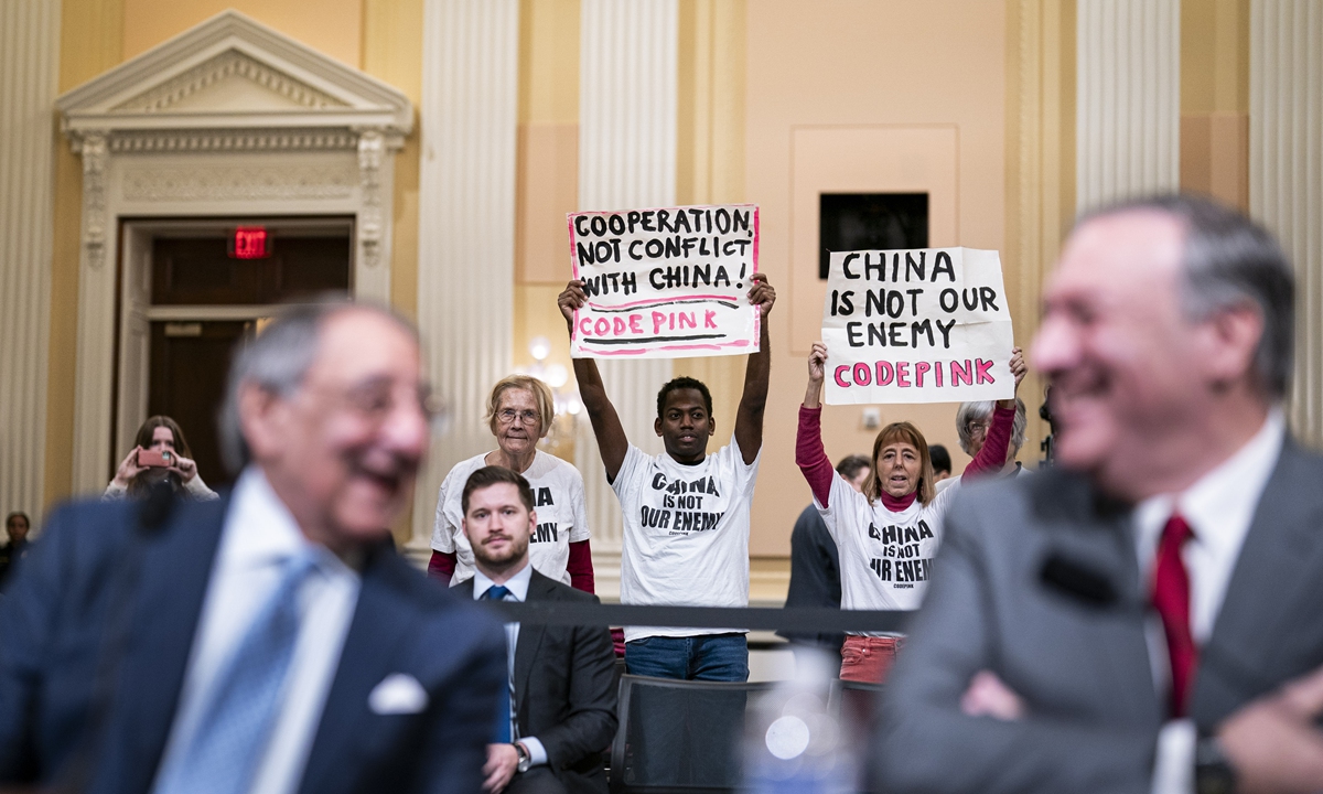 Demonstrators holding signs that read 